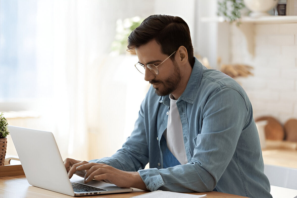 Man typing on his laptop